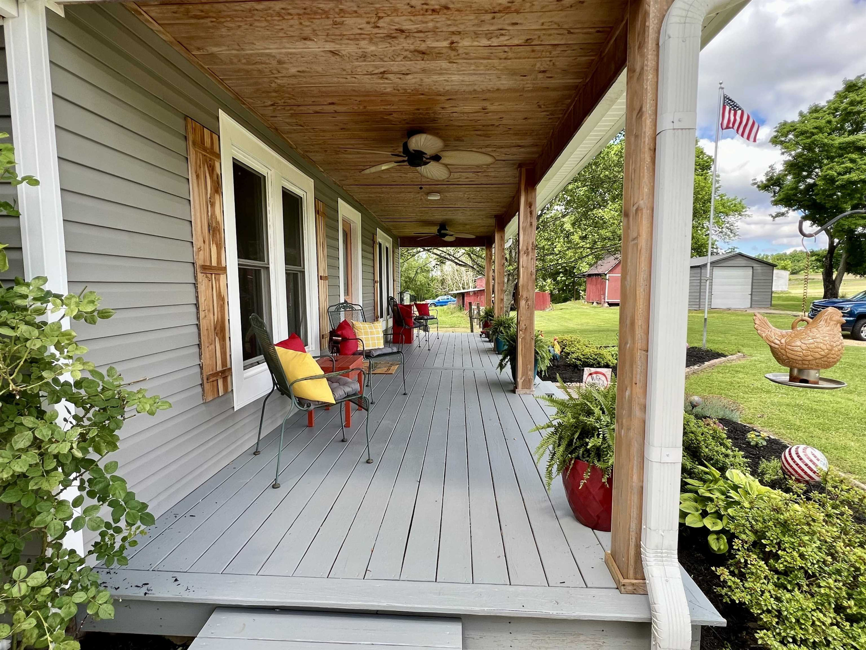 2390 Dr Lewis Road Ripley, TN 38063 - Photo 5 of 48 a view of a patio with table and chairs potted plants with wooden floor and plants