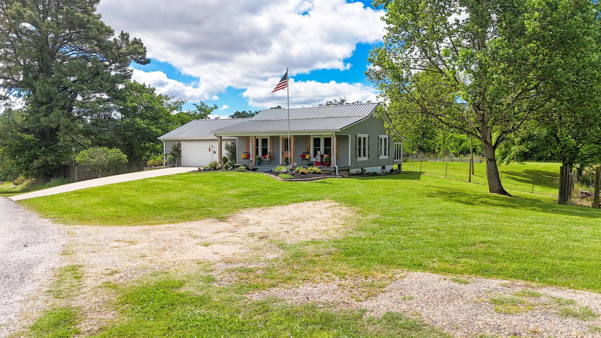 2390 Dr Lewis Road Ripley, TN 38063 - Photo 9 of 48 a view of a white house with a big yard and large trees