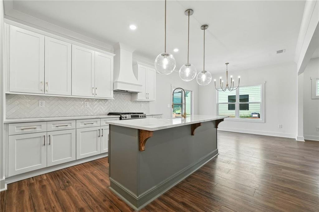125 Old Alabama Road Southeast Emerson, GA 30137 - Photo 7 of 37 a large kitchen with kitchen island white cabinets and stainless steel appliances