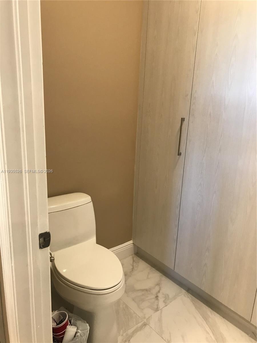 10872 Southwest 89th Street, Unit 10872 Miami, FL 33176 - Photo 14 of 25 a white toilet sitting next to a shower