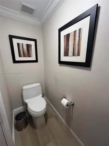 a white toilet sitting next to a bathroom sink
