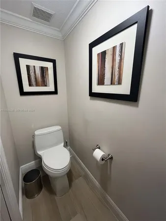 a white toilet sitting next to a bathroom sink