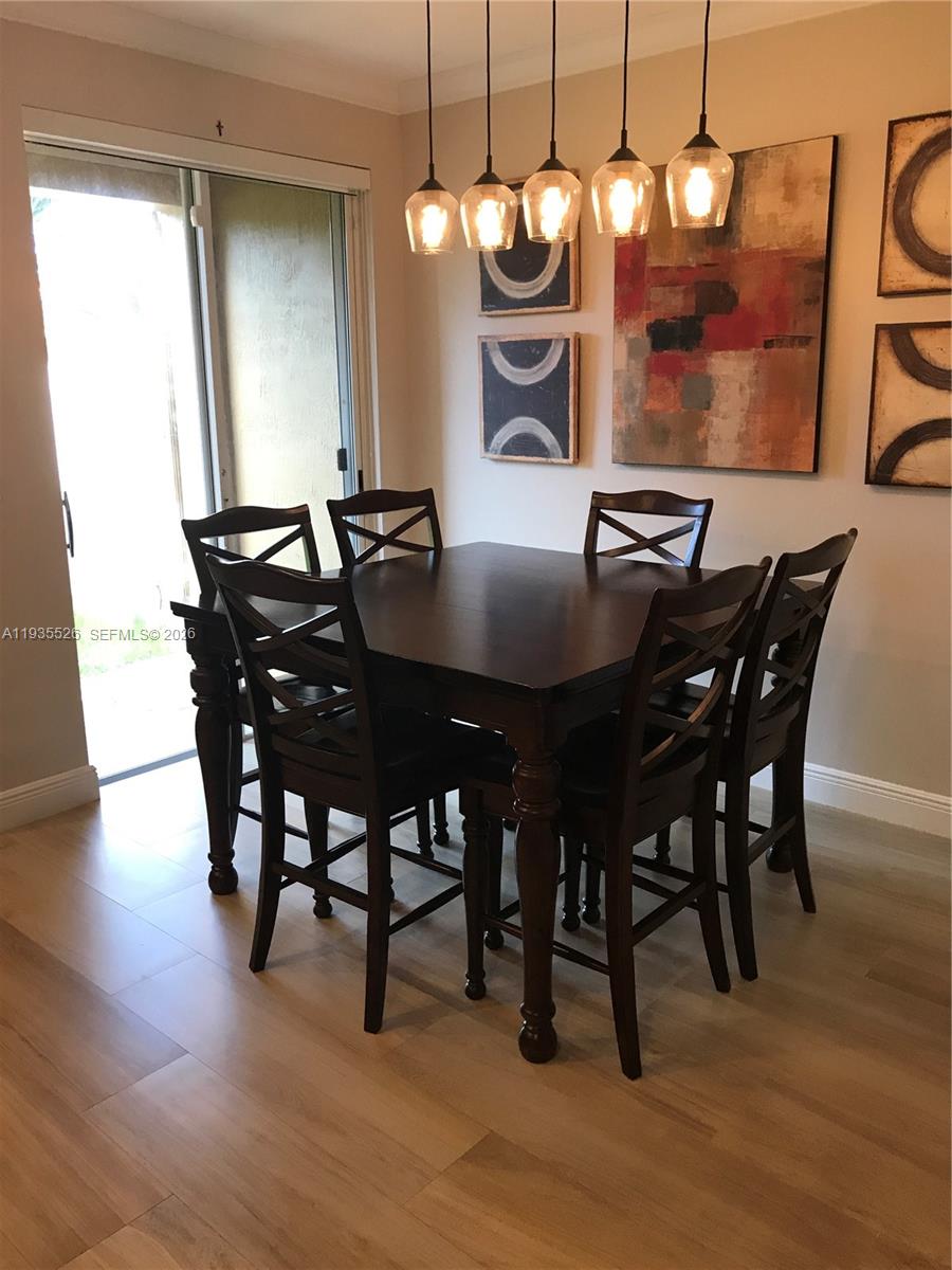10872 Southwest 89th Street, Unit 10872 Miami, FL 33176 - Photo 5 of 25 a view of a dining room with furniture and wooden floor