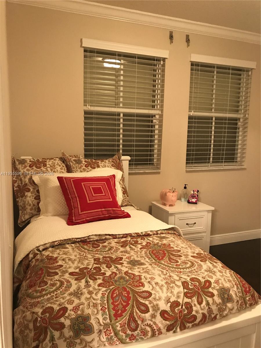 10872 Southwest 89th Street, Unit 10872 Miami, FL 33176 - Photo 9 of 25 a bedroom with a bed and window