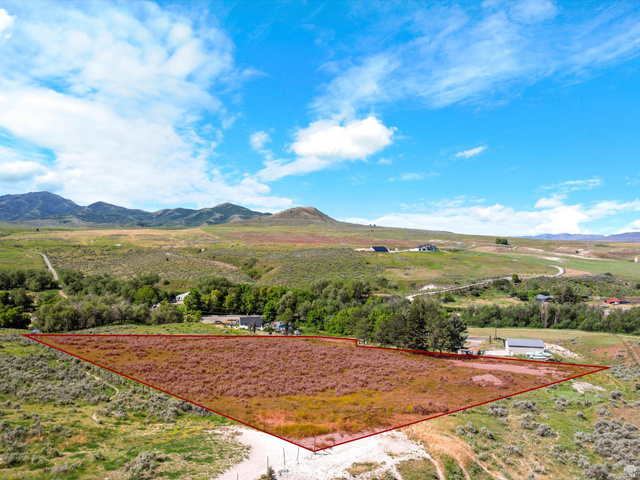15610 North Beaver Dam Road, Unit 2 Collinston, UT 84306 - Photo 3 of 10 Expansive parcel of undeveloped land outlined in red, featuring natural vegetation and a gravel access path