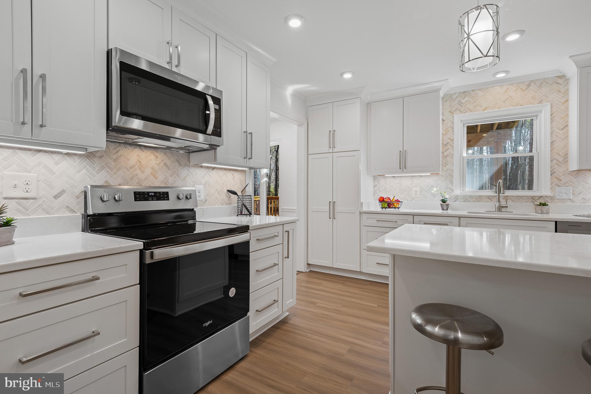 5235 Chalk Point Road West River, MD 20778 - Photo 12 of 69 a kitchen with a sink stainless steel appliances and white cabinets