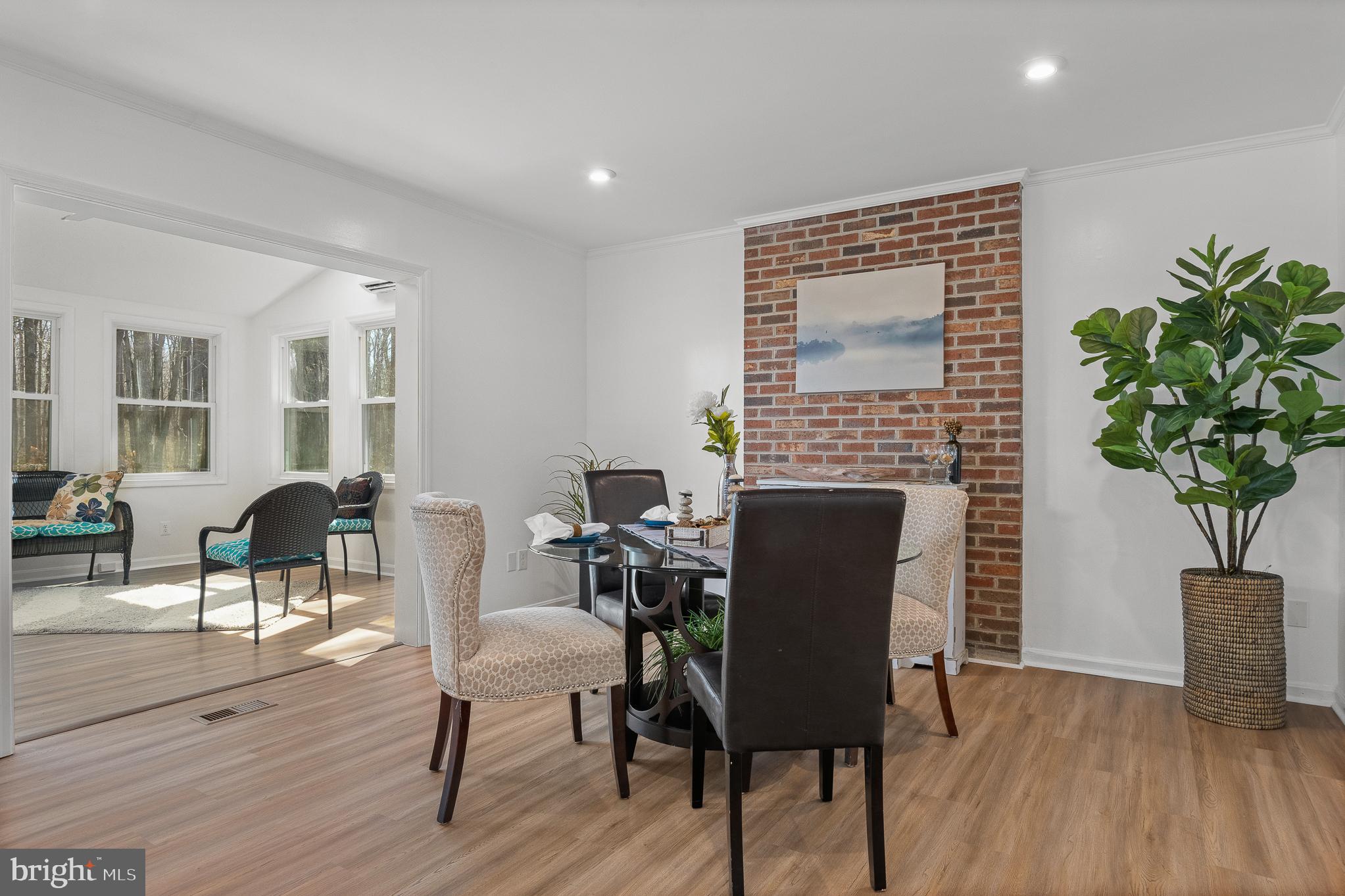 5235 Chalk Point Road West River, MD 20778 - Photo 16 of 69 a dining room with furniture potted plants and wooden floor