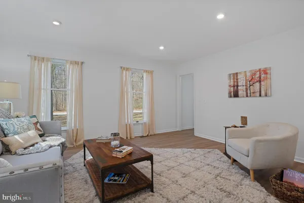 a living room with furniture a window and a flat screen tv