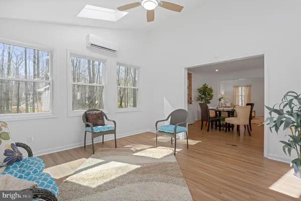 a view of a livingroom with furniture wooden floor and a large window