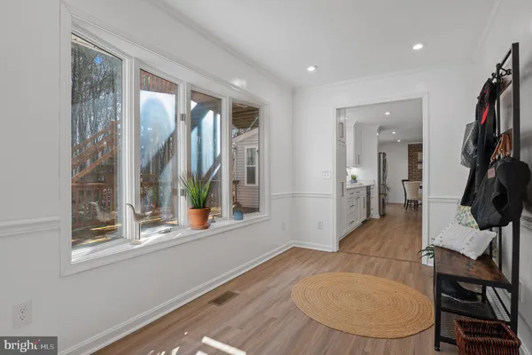 a view of a hallway with wooden floor and stairs