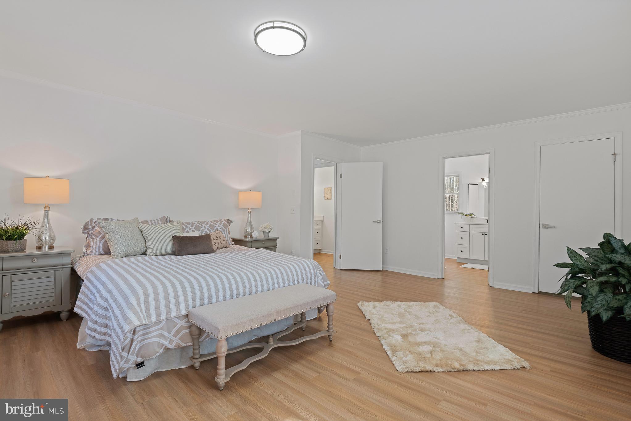 5235 Chalk Point Road West River, MD 20778 - Photo 39 of 69 a bedroom with a bed and a potted plant