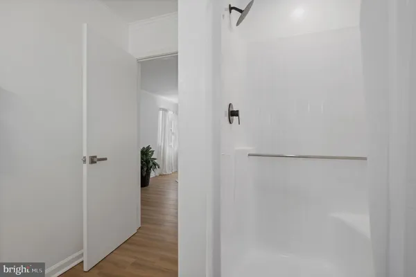 a view of a small space with wooden floor and a window