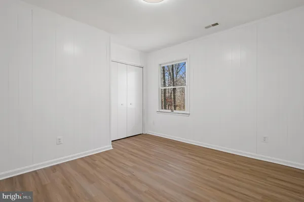 an aerial view of a house with backyard space and balcony