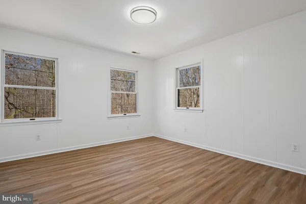 a picture of a bench in front of a wall