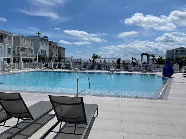 a view of a patio with swimming pool and furniture