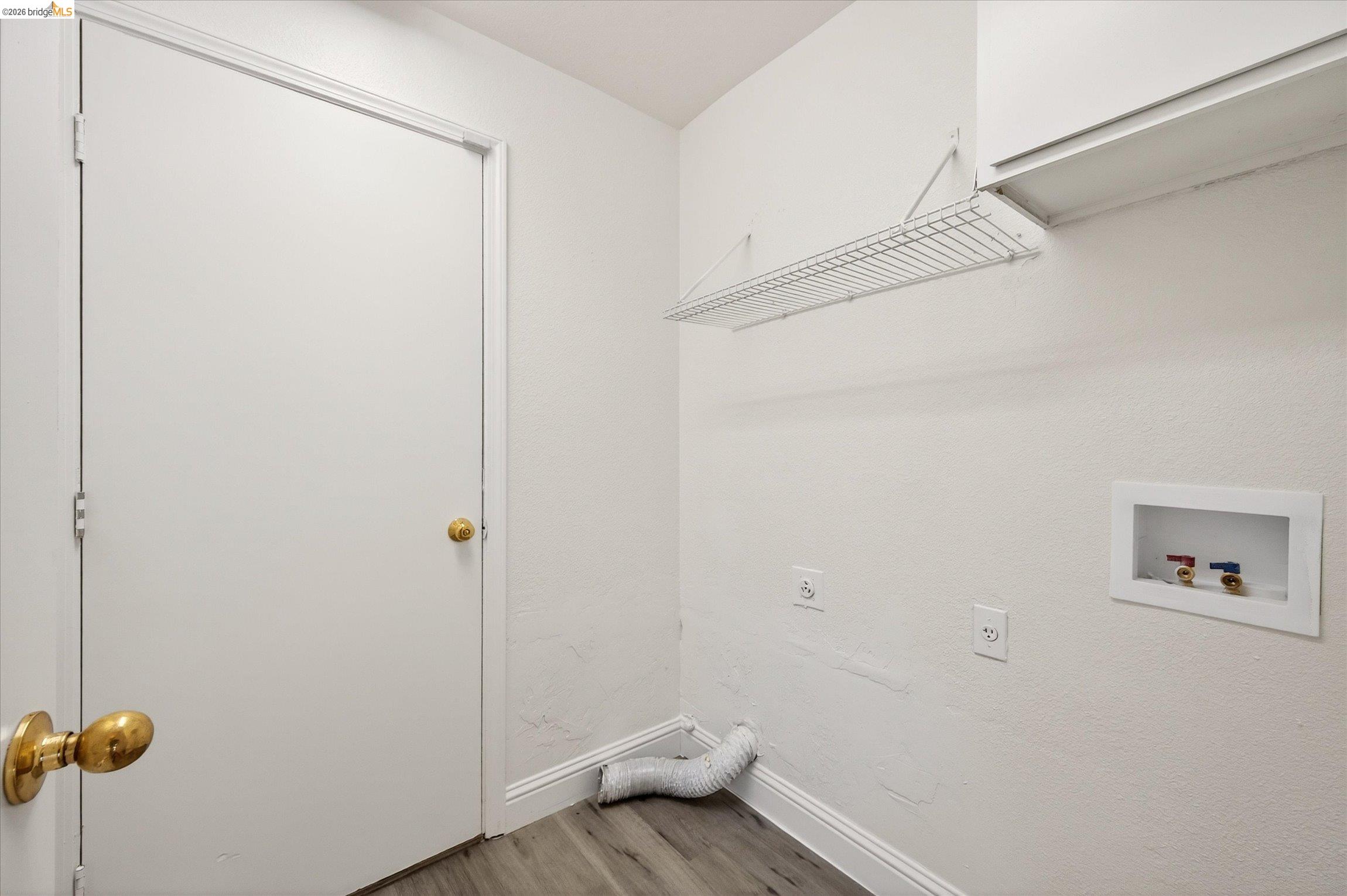 1120 Deerpark Road Oakley, CA 94561 - Photo 27 of 30 Dedicated utility space featuring wood-finish flooring, white walls, and a built-in wire shelf
