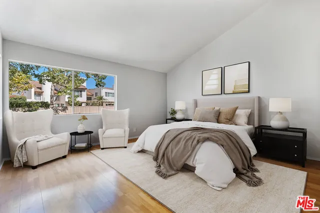 a bedroom with a bed and a couch