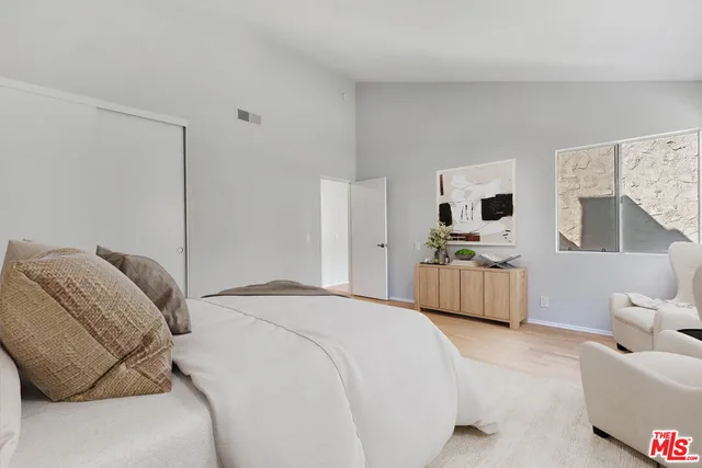 a bedroom with a bed a couch and dresser