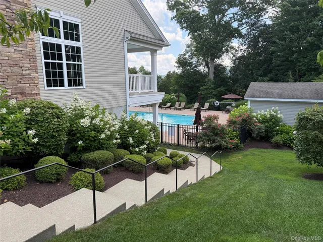 a view of a house with a garden and pathway