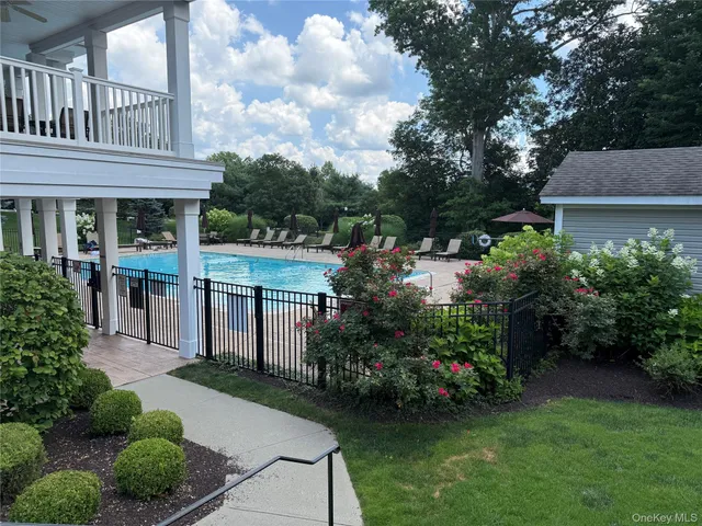 a view of a hallway view with wooden floor and a living room