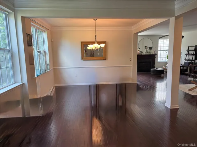 a view of front door with wooden floor and windows
