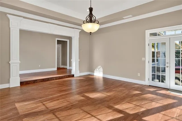 a large kitchen with a center island wooden floor stainless steel appliances and windows