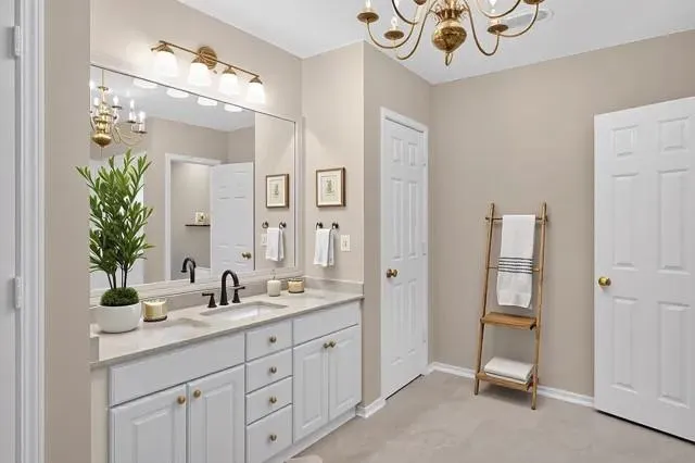a kitchen with a refrigerator and white cabinets