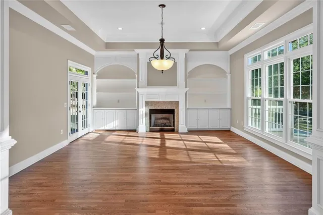 a kitchen with stainless steel appliances kitchen island granite countertop a stove a sink a refrigerator and a wooden floor