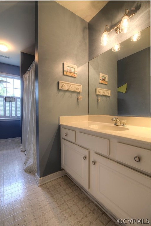 707 Biggin Pond Road Midlothian, VA 23114 - Photo 21 of 36 a bathroom with a double vanity sink and mirror