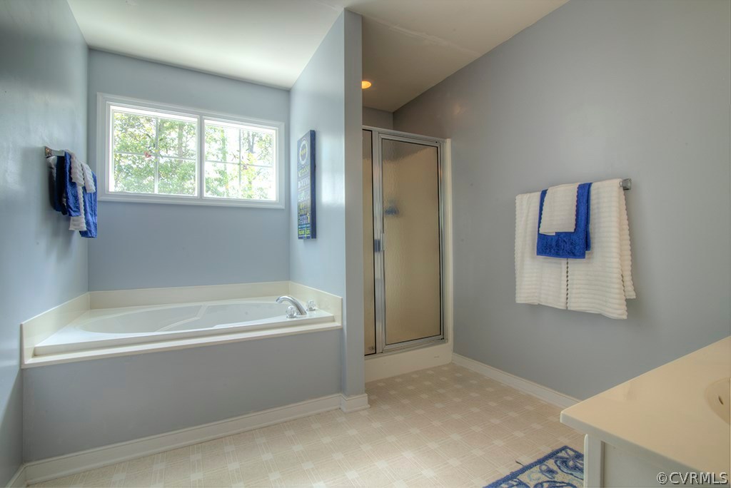 707 Biggin Pond Road Midlothian, VA 23114 - Photo 25 of 36 a bathroom with a bathtub and a window