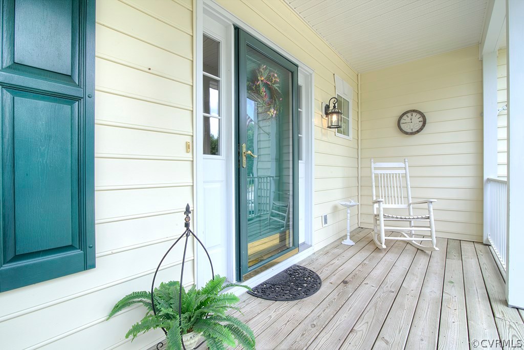 707 Biggin Pond Road Midlothian, VA 23114 - Photo 3 of 36 a view of a balcony with chairs and wooden floor