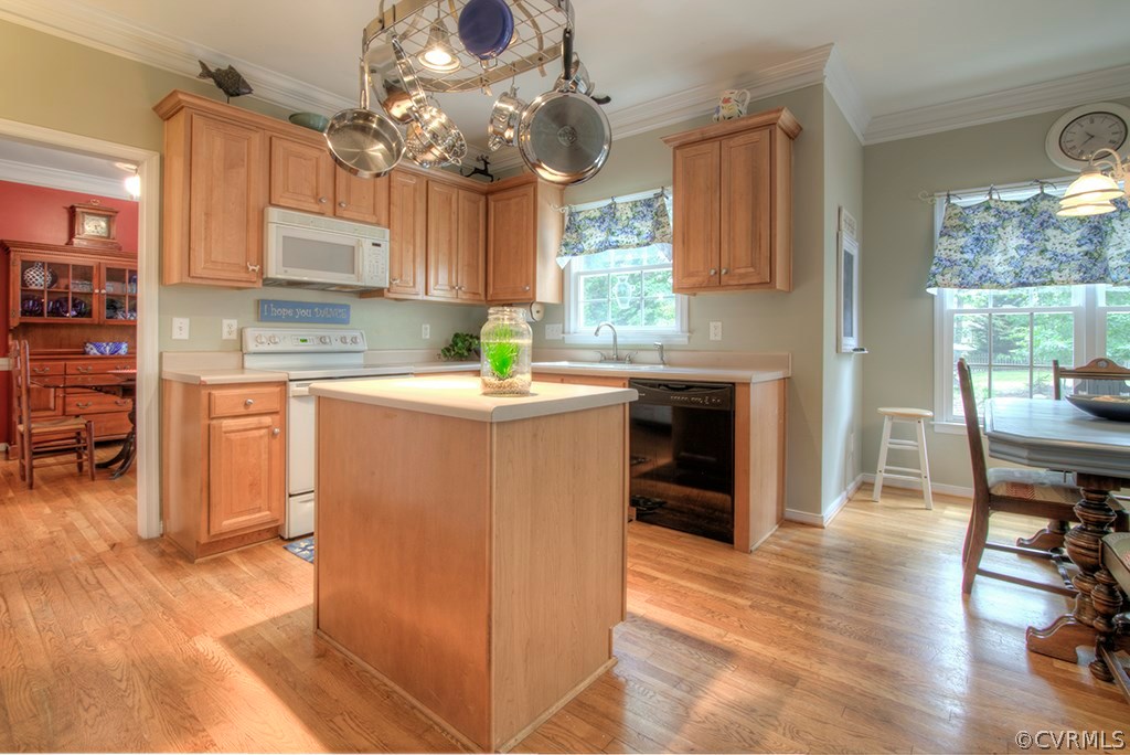 707 Biggin Pond Road Midlothian, VA 23114 - Photo 8 of 36 a kitchen with stainless steel appliances granite countertop a refrigerator a sink dishwasher a stove and a dining table with wooden floor