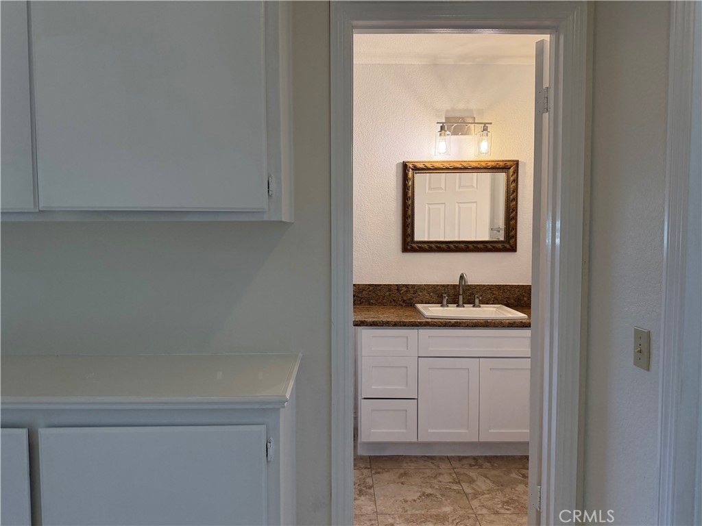 2421 Mangular Avenue Corona, CA 92882 - Photo 17 of 25 a bathroom with a sink and a mirror