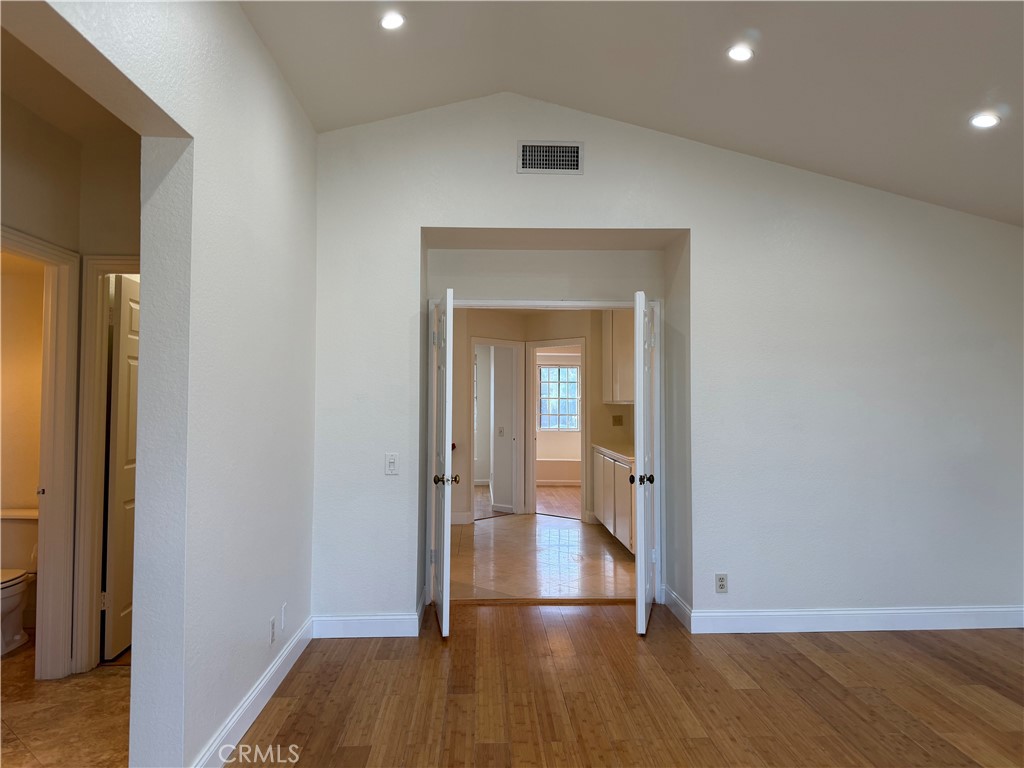 2421 Mangular Avenue Corona, CA 92882 - Photo 18 of 25 an empty room with wooden floor and entrance