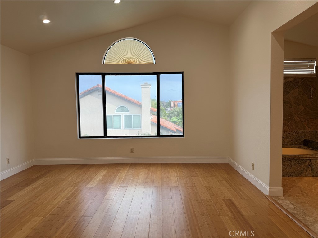 2421 Mangular Avenue Corona, CA 92882 - Photo 19 of 25 an empty room with wooden floor and windows