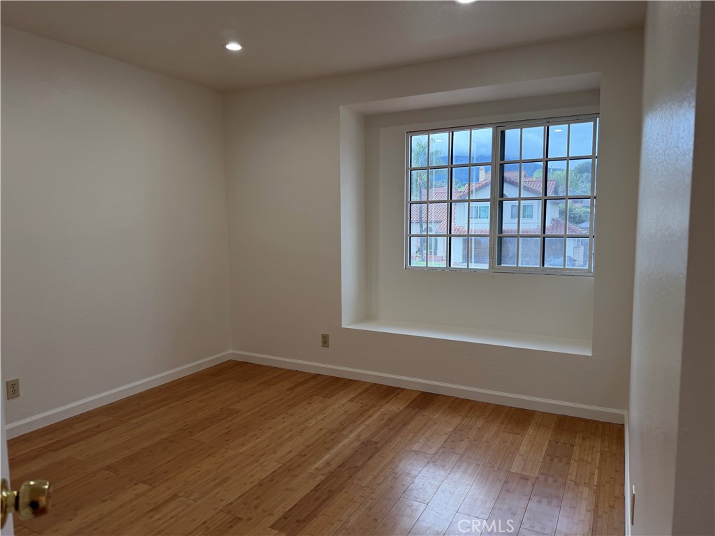 2421 Mangular Avenue Corona, CA 92882 - Photo 23 of 25 wooden floor and window in empty room