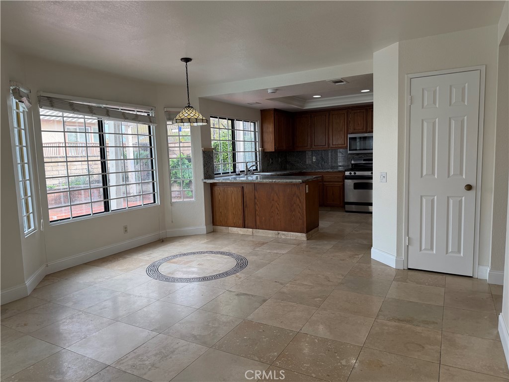 2421 Mangular Avenue Corona, CA 92882 - Photo 5 of 25 Kitchen open up to dining area