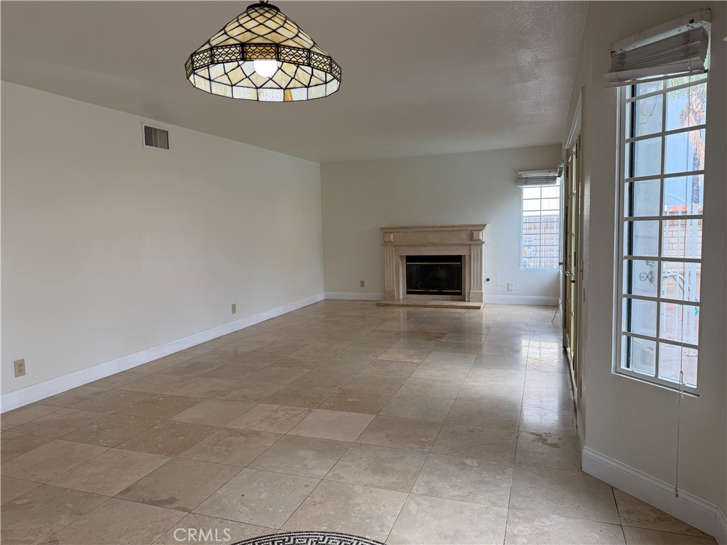 2421 Mangular Avenue Corona, CA 92882 - Photo 6 of 25 Dining area open up to living room with fireplace