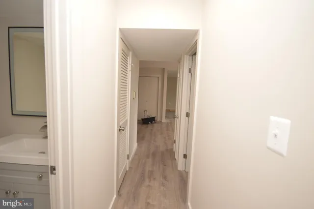 a view of a hallway with wooden floor