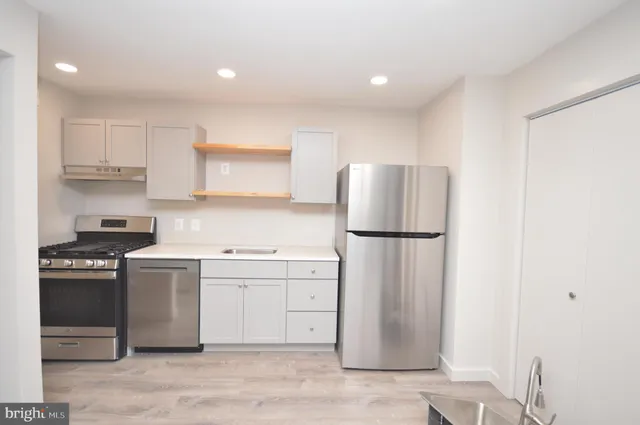 a kitchen with a refrigerator sink and stove