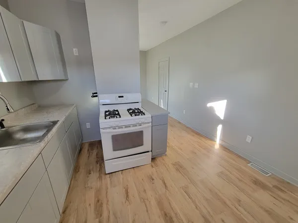 a kitchen with a stove a sink and a microwave