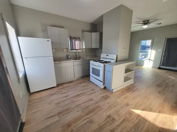 a kitchen with stainless steel appliances granite countertop a stove a refrigerator and a sink