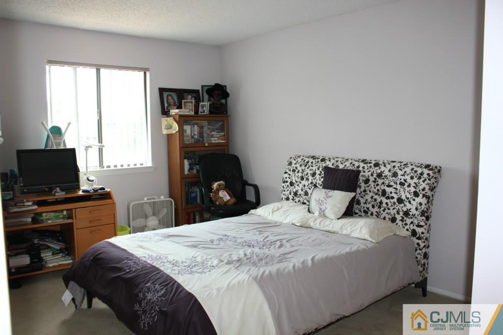 5205 Hana Road Edison, NJ 08817 - Photo 11 of 15 a bedroom with a bed and a tv