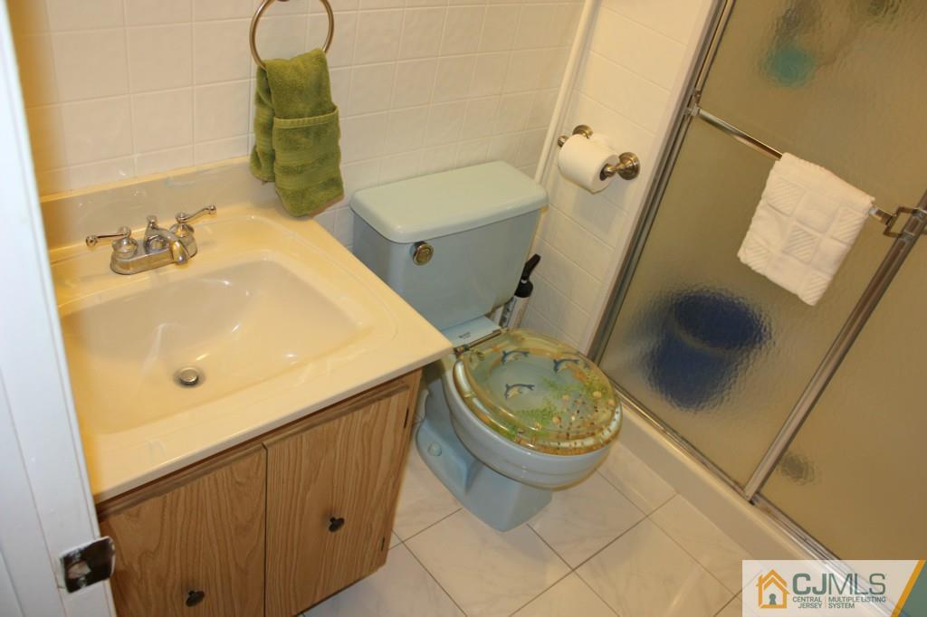 5205 Hana Road Edison, NJ 08817 - Photo 13 of 15 a bathroom with a sink and a toilet