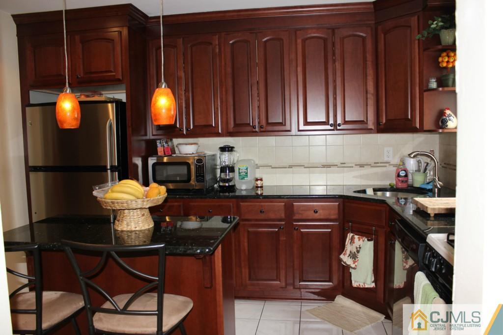 5205 Hana Road Edison, NJ 08817 - Photo 6 of 15 a kitchen with a sink cabinets and appliances