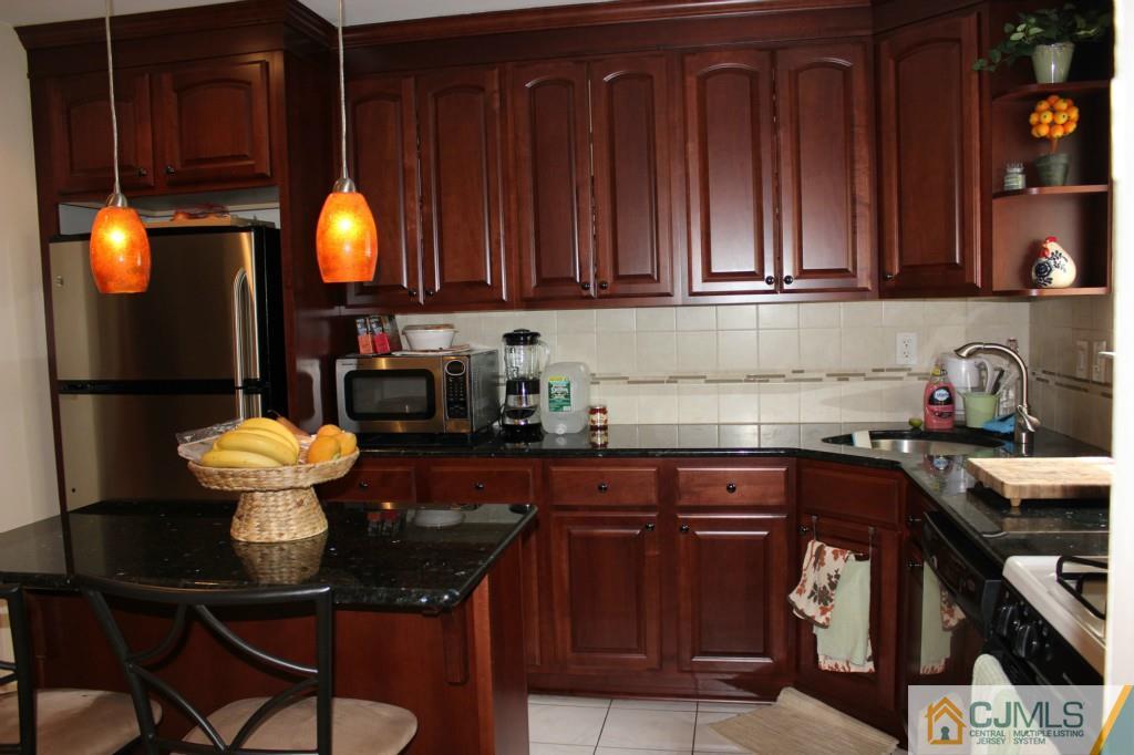 5205 Hana Road Edison, NJ 08817 - Photo 7 of 15 a kitchen with a sink cabinets and appliances