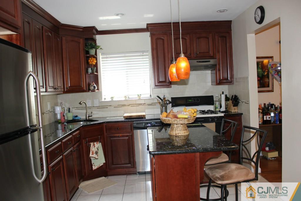 5205 Hana Road Edison, NJ 08817 - Photo 8 of 15 a kitchen with a sink stove and refrigerator
