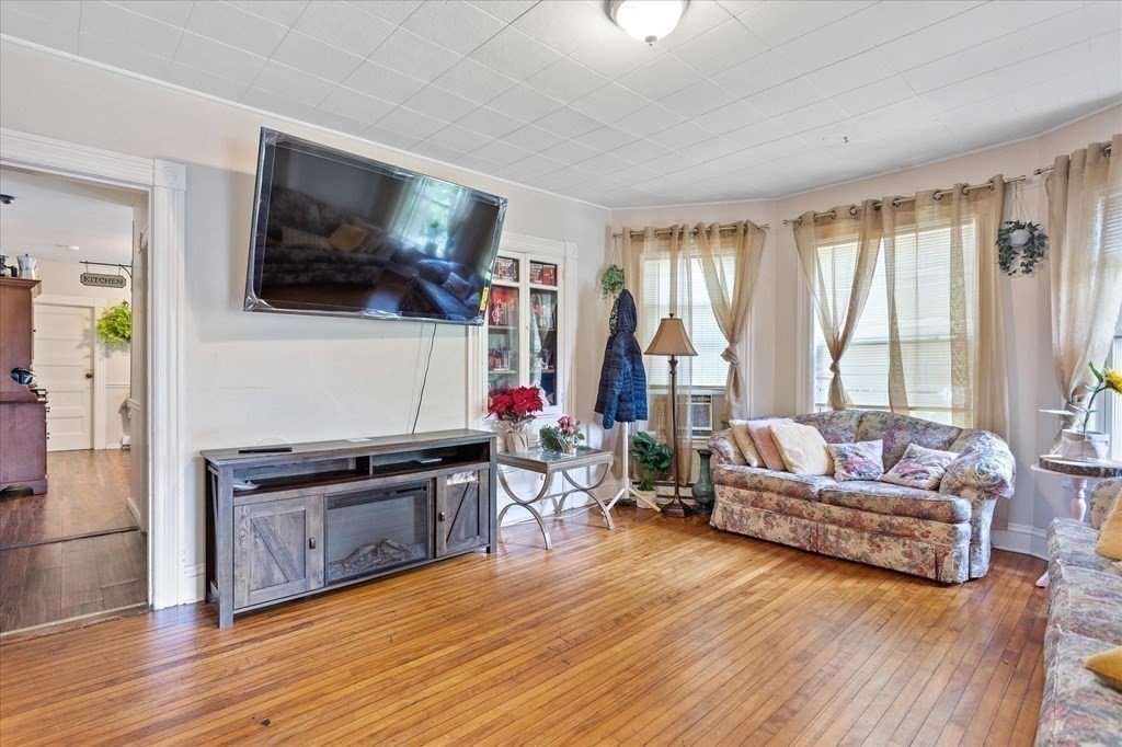1550-1552 Main Street Worcester, MA 01603 - Photo 17 of 34 a living room with furniture and a flat screen tv