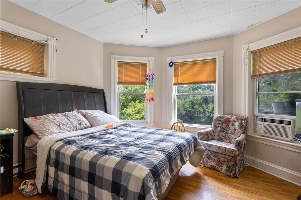 1550-1552 Main Street Worcester, MA 01603 - Photo 20 of 34 a bed sitting in a bedroom next to a window