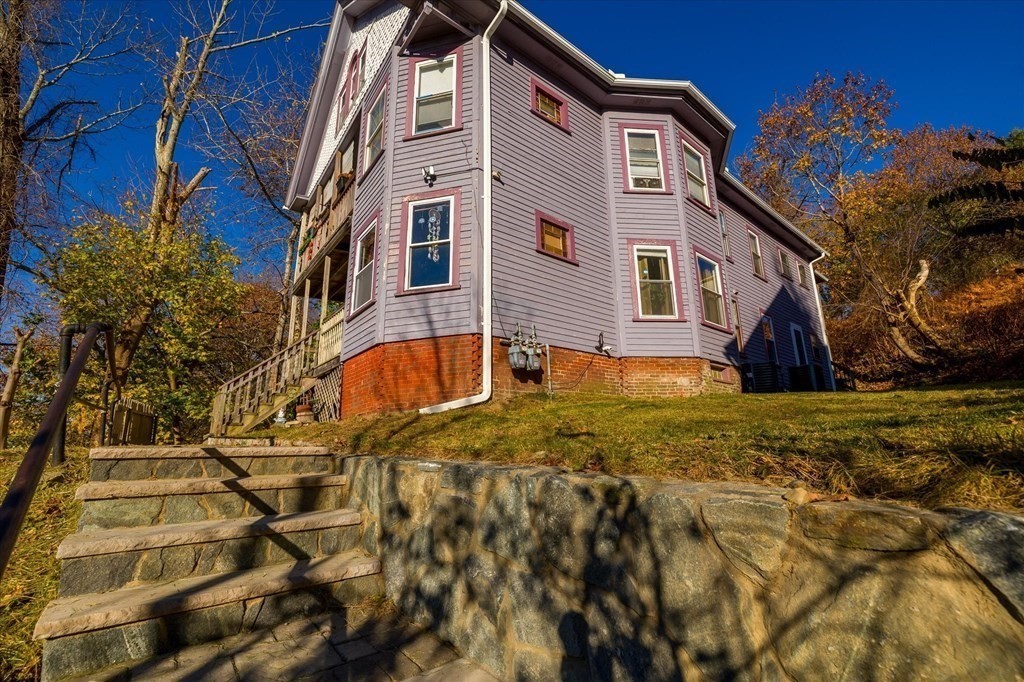 1550-1552 Main Street Worcester, MA 01603 - Photo 2 of 34 a front view of a house with a yard